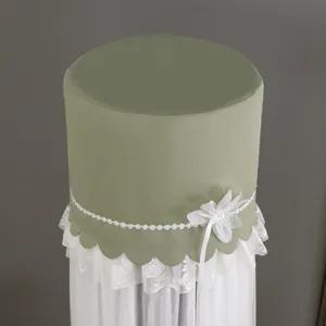 Sage green cylindrical standing air conditioner cover with elegant white lace and floral decor.