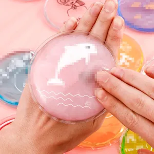 Portable self-heating hand warmer, cute cartoon dolphin design, reusable winter warming gadget.