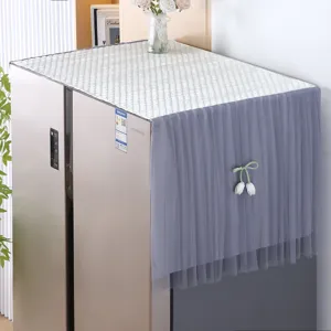 Detail of minimalist refrigerator dust cover featuring white top and grey tulle tulip accent.
