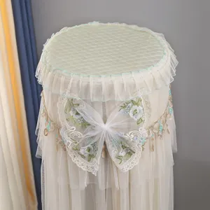 Detail view of vertical cylindrical air conditioner dust cover with elegant lace embroidery bow.