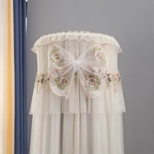 Vertical cylindrical air conditioner dust cover with elegant lace mesh and embroidered bow detail.