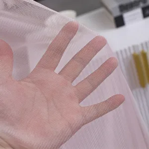 Pink mesh fabric detail of vertical air conditioner dust cover, breathable and semi-transparent.