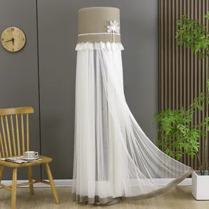 Vertical cylindrical air conditioner dust cover with delicate lace and sheer mesh design for home.