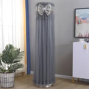 Detail view of gray mesh cylinder AC dust cover with elegant lace and bow decoration.