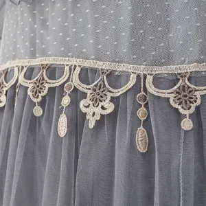 Close-up detail of grey mesh fabric with exquisite beige embroidery lace trim for cover.