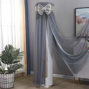 Detail view of a grey cylindrical air conditioner dust cover with lace mesh and elegant bow decor.