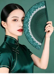 Detailed view of traditional Chinese silk folding fan with delicate lace and bamboo ribs.