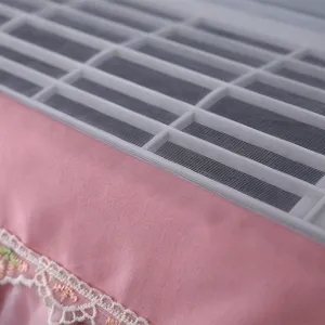 Pink lace air conditioner dust cover detail shot, elegant fabric hanging AC protector, home decor.
