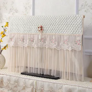 Copertura antipolvere trapuntata per TV in pizzo con elegante ricamo floreale e nappa decorativa.