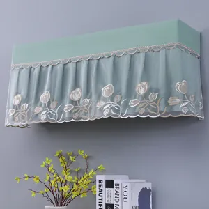 Detail view of green wall-mounted air conditioner cover with delicate lace and tulip embroidery.