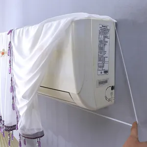 Housse anti poussière pour climatiseur avec pompons de perles et tissu blanc.
