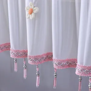 Détail de housse de clim transparente blanche, bordure perlée rose et joli détail floral.