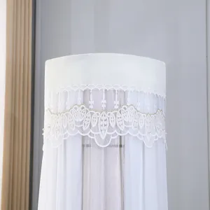 White cylindrical vertical air conditioner dust cover with delicate lace embroidery.