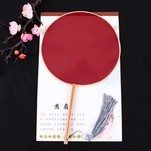 Traditional Chinese round fan with wooden handle, elegant red silk surface and tassel decor.