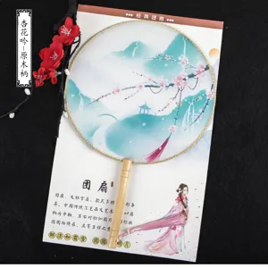Traditional Chinese silk round fan with wooden handle elegant floral landscape design for photography