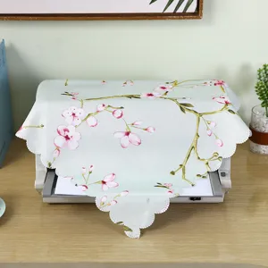 Fabric dust cover detail featuring elegant cherry blossom pattern and lace trim for home or office.