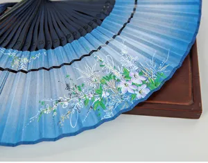 Elegant blue gradient silk folding fan detail view, traditional floral art design with dark ribs.