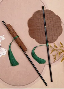 Detailed view of traditional Chinese bamboo fan with elegant green tassel, vintage style.