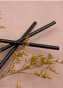 Detailed view of traditional style black bamboo fan ribs and stems with dried flower decor.