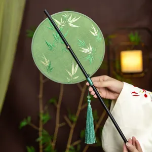 Traditional Chinese round fan with bamboo leaf embroidery, elegant green tassel and portable handle.