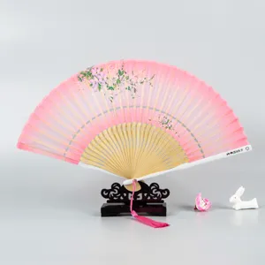 Traditional Chinese style silk folding fan with elegant floral design and wooden frame display.
