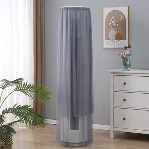 Detail view of the elegant gray mesh vertical air conditioner cover in a cozy living room setting.