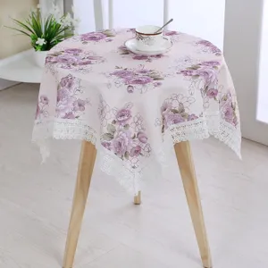 Pink floral tablecloth with white lace trim, round fabric table cover for home decor, cozy dining.