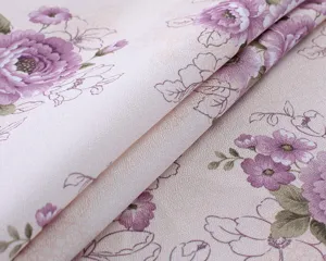 Cotton linen tablecloth fabric detail view, elegant purple floral pattern on pink background.