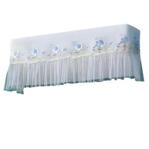 Wall-mounted air conditioner dust cover with blue flower embroidery and mesh fringe design.