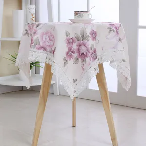 Detailed view of pastoral style floral tablecloth with delicate lace trim for home decor.