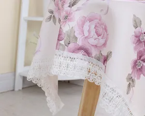 Pink floral tablecloth with delicate white lace trim, vintage cotton linen fabric for dining.