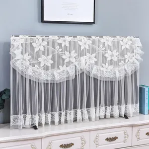 Detailed view of the elegant white lace TV dust cover featuring delicate floral embroidery.