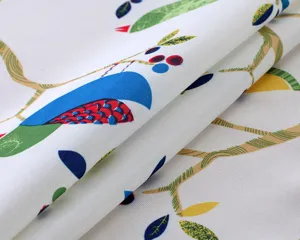 Cotton linen fabric detail, fresh bird and branch print tablecloth texture close up