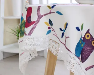Cotton linen tablecloth detail featuring cute owl bird print and delicate white lace edge.