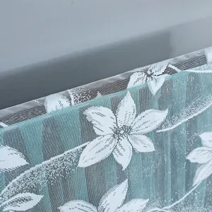 Close-up detail of white floral lace TV dust cover fabric, showing delicate texture.