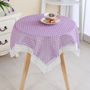 Chic purple polka dot tablecloth with delicate white lace trim for home coffee table decor.