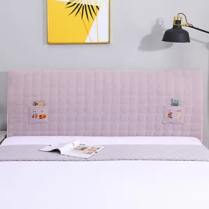 Pink quilted headboard cover detail featuring convenient side storage pockets with cute embroidery.