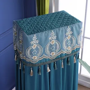 Detailed view of teal standing air conditioner dust cover with lace embroidery and tassels.