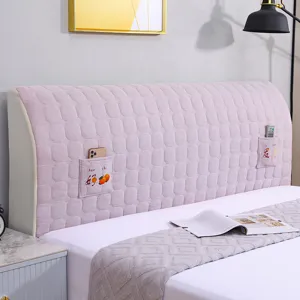 Pink quilted bed headboard cover with side storage pockets, thickened dustproof bedroom decor.