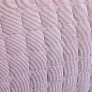 Quilted headboard cover fabric detail texture close-up soft pink thick washable material