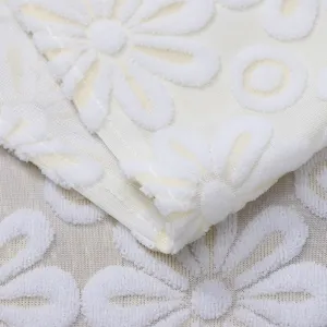 Detail view of white lace appliance cover cloth featuring elegant embroidered floral daisy pattern.
