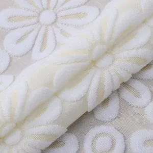 White lace floral embroidery fabric cover detail shot, elegant home appliance protector.