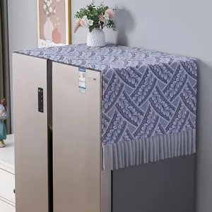 Detailed view of the refrigerator dust cover featuring elegant leaf patterns and pleated fringe.