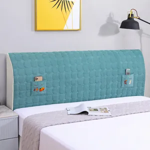 Quilted headboard cover detail, soft thick fabric with side pockets for bedroom use.