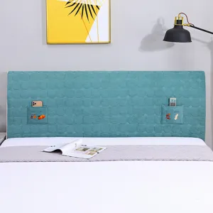 Quilted bedside headboard cover detail showing convenient side storage pockets and embroidery.