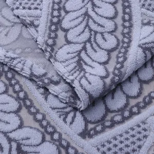 Close up view of grey lace appliance cover fabric showing detailed floral embossed texture.