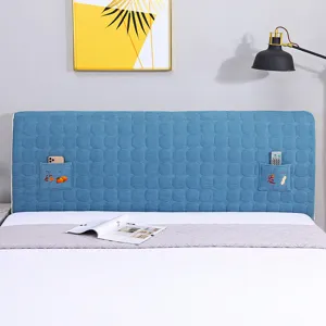 Detailed view of the quilted bed headboard cover with convenient side storage pockets blue fabric.