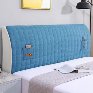 Thickened blue bedside dust cover with storage pockets, soft upholstered headboard protector.