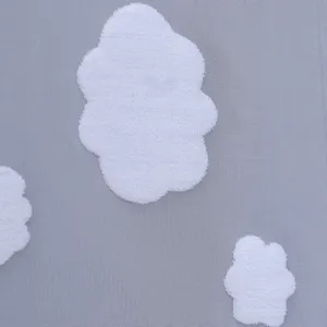 Detailed close-up view of light grey mesh fabric featuring cute white plush cloud patches.