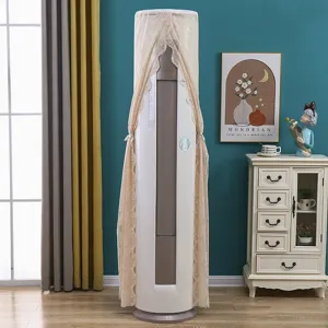 Detail view of a lace embroidered cylindrical vertical air conditioner dust cover in room setup.